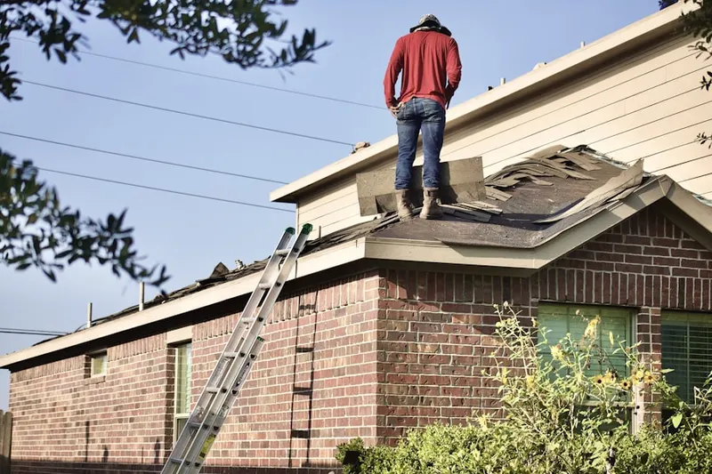 Professional roofer working on a residential roof in Gwinnstone